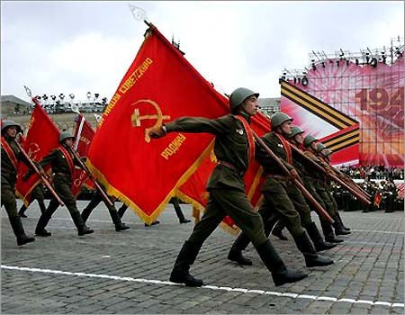 Soviet soldiers marching with red flags